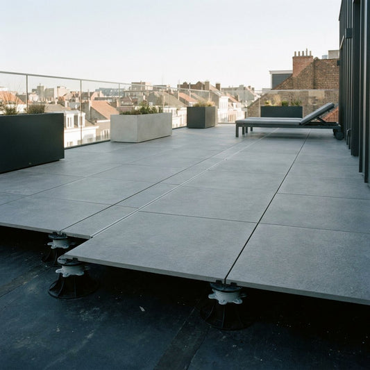 Modern dakterras met keramische tegels op tegeldragers, strakke afwatering en veilige loopruimte, gefotografeerd bij zacht daglicht in stedelijke setting.